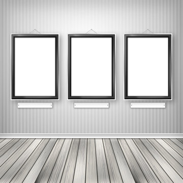 Three empty frames on a wall