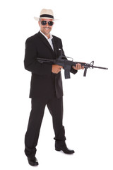 Naklejka premium Mature Businessman Holding Gun
