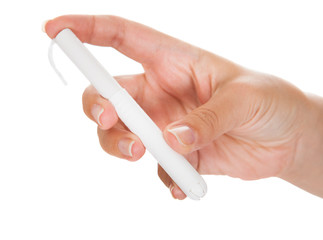 Close-up of hand holding tampon