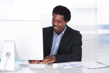 Obraz na płótnie Canvas Happy Businessman Working On Computer