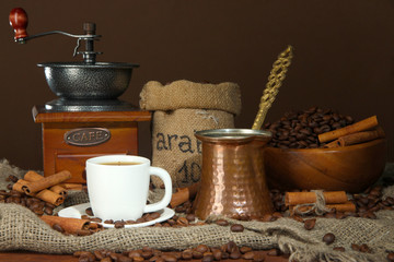 Metal turk and coffee cup on dark background