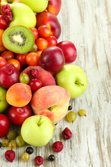Assortment of juicy fruits, on wooden background