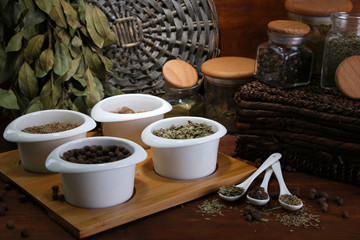 Assortment of spices in  white spoons and bowls,