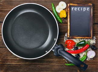 rice with vegetables next to a frying pan