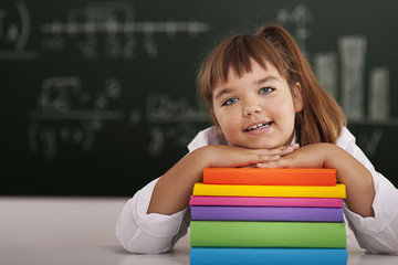 Cute little girl with her books