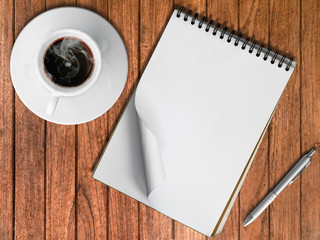 Sketch book Silver pen and White cup of hot coffee