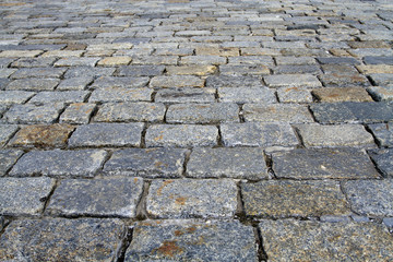 Spotted cobblestone background in perspective