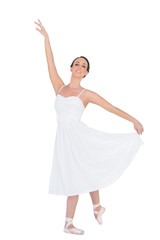 Fototapeta na wymiar Smiling young ballet dancer posing with her leg back