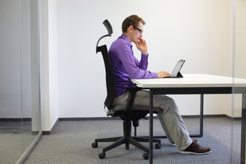 correct sitting position at desk with tablet - obrazy, fototapety, plakaty