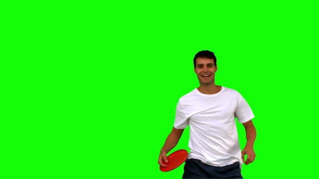 Man catching a frisbee on green screen