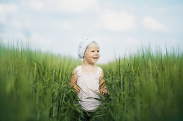 happy little girl in high grass