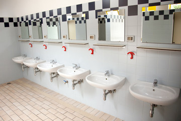 row of washbasins in building of camping in italy