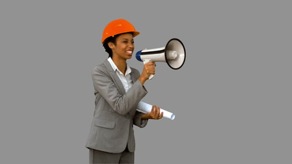 Happy architect using a megaphone on grey screen - Powered by Adobe