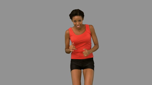 Woman jogging on grey screen