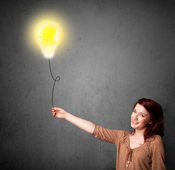 Woman holding a lightbulb balloon