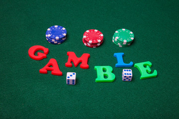 Gamble letters with poker chips and dice