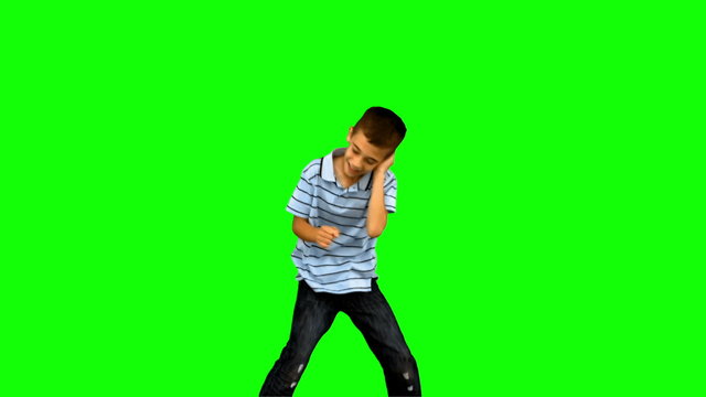 Little boy dancing on green screen
