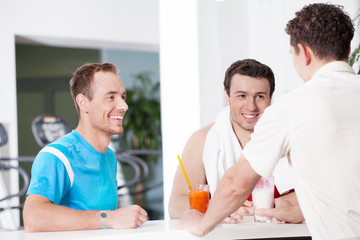 Healthy lifestyle. Two confident men in juice bar