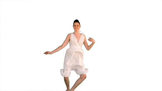 Beautiful model in white dress jumping