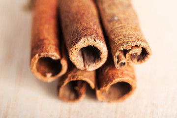 cinnamon sticks on wood close up