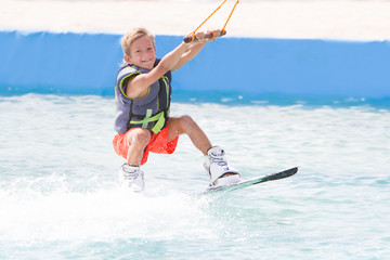 young child boy wake boarding