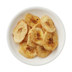 Dried banana chips in a bowl isolated on white background