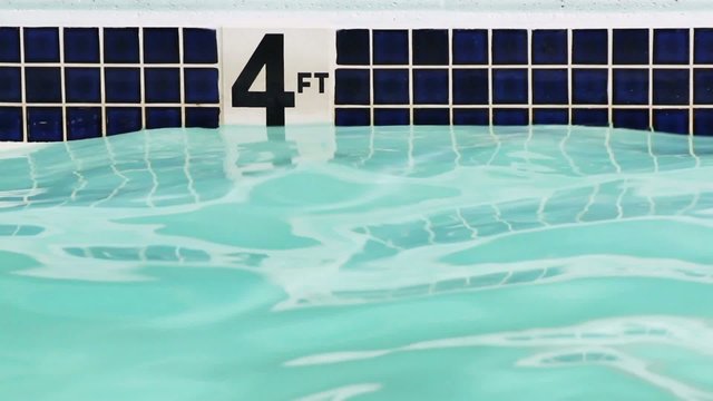 Four foot depth marker on side of swimming pool