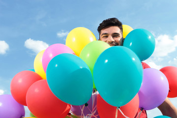 Fototapeta na wymiar casual man surrounded by baloons