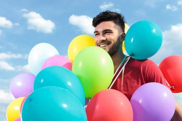 Fototapeta na wymiar casual man with baloons all over him