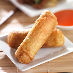 chinese egg rolls with sauce on plate