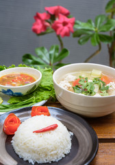 rice on black dish and meat soup with