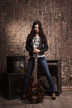 Rock babe in leather jacket with electric guitar