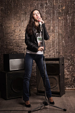 Rock babe singing into a microphone
