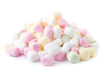 A pile of small colored puffy marshmallows isolated on white bac