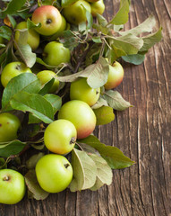 Organic Apples with leaves on wooden background