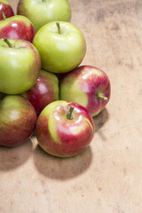 pile of apples on a wooden background