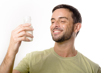 Young Handsome Man with Beard drinking Milk