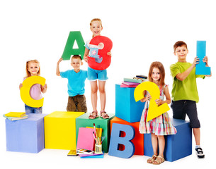 Children sitting at cube.