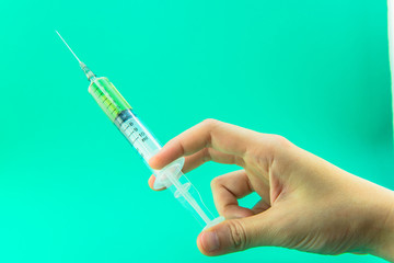 Syringe with a medicine in a female hand