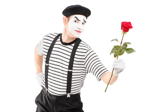 Mime artist giving a rose flower