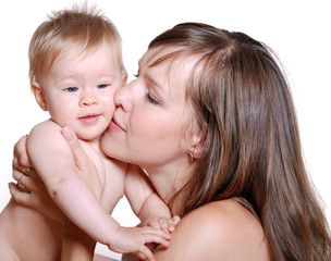 portrait of happy mother kissing her baby over white