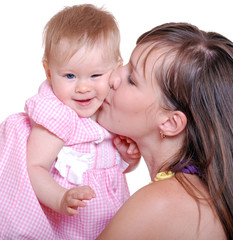 portrait of happy mother kissing her baby on a white