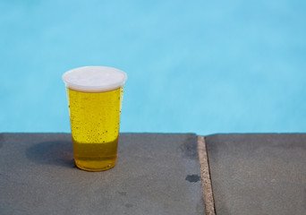 Golden lager or beer in disposable plastic cup