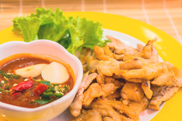 korean pork barbeque with sauce and vegetables on a side