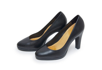 Close-up of female high-heeled shoes over white background