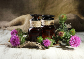 Medicine bottles with thistle flowers