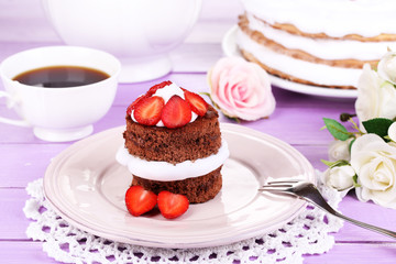 Chocolate cake with strawberry on wooden table close-up