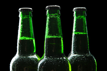Bottles of beer on black background