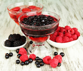 Jelly with fresh berries on wooden table close up