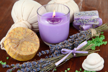Naklejka premium Still life with lavender candle, soap, massage balls, bottles,